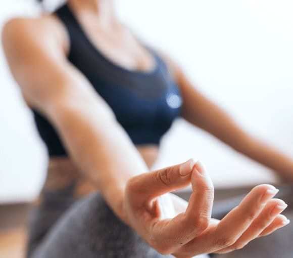 A close-up of a person practicing mindfulness through yoga, reflecting the holistic healing approach at a drug and alcohol rehab center in Louisville, KY.