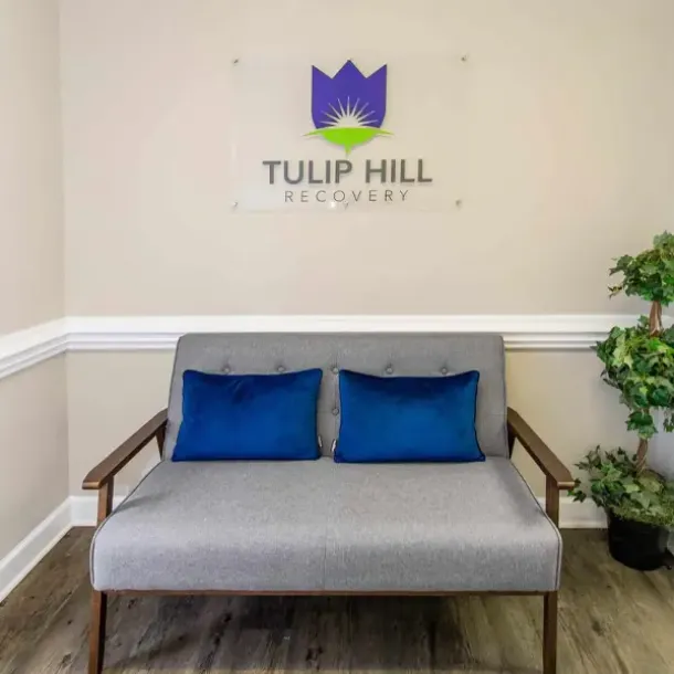 A cozy reception area with a Tulip Hill Recovery logo, highlighting the professional yet warm ambiance of drug and alcohol treatment centers in Tennessee.