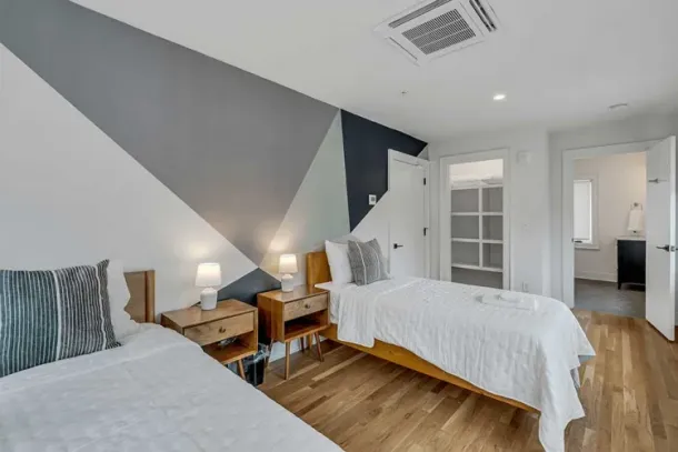 A cozy and stylishly designed bedroom with twin beds at a drug and alcohol detox center in Nashville, offering a tranquil and comfortable environment for recovery.