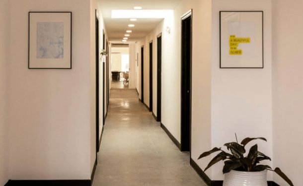 A bright hallway at a drug and alcohol rehab center in Louisville, KY, featuring minimalistic decor and inspiring artwork to create a calm and welcoming atmosphere.