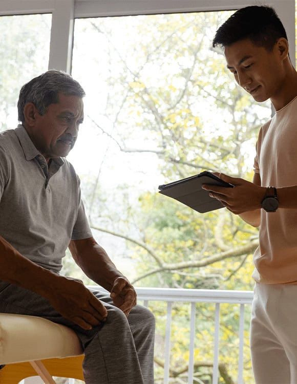 A rehabilitation professional discussing personalized recovery plans with an older patient at the Drug and Alcohol Rehab Center in Murfreesboro.
