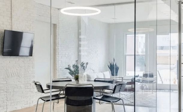 A modern meeting room with glass walls at a drug and alcohol rehab center in Louisville, KY, designed for group therapy and collaborative discussions.