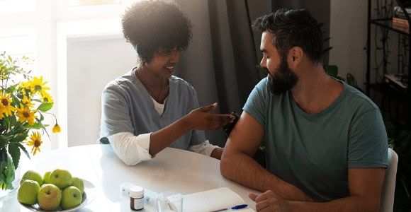 A compassionate medical professional attentively helping a distressed individual, showcasing the personalized care provided at a drug and alcohol rehab center in Louisville, KY.
