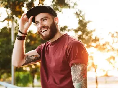 A smiling individual in casual attire enjoying outdoor recovery moments, representing hope and positivity at drug and alcohol treatment centers in Tennessee.