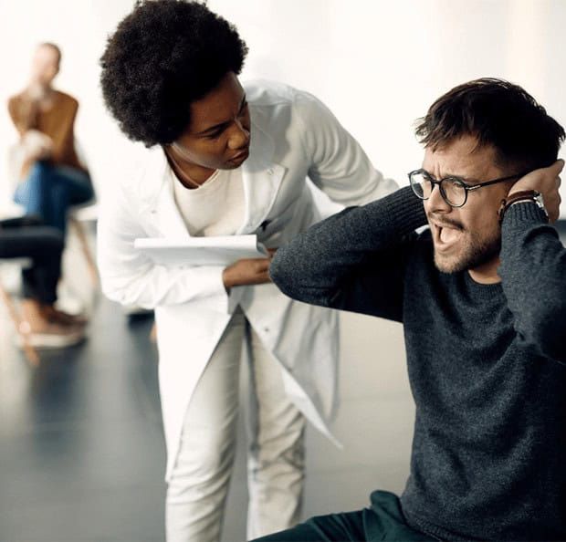 A compassionate medical professional attentively helping a distressed individual, showcasing the personalized care provided at a drug and alcohol rehab center in Louisville, KY.